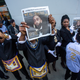 Attendees at Nipsey Hussle’s memorial service hold up copies of the Nation of Islam’s Final Call newspaper with Hussle on the cover April 11, 2019.